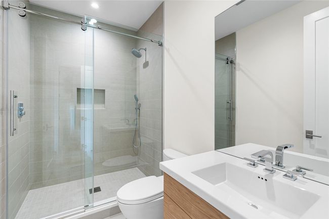 Full bathroom featuring toilet, a stall shower, and vanity | Image 31