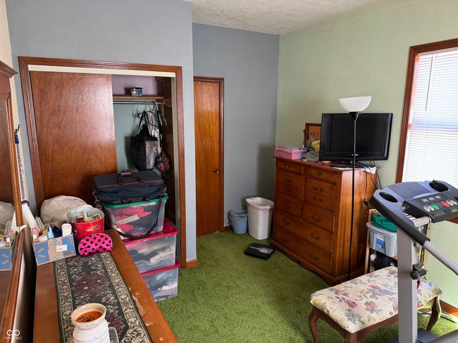 carpeted bedroom featuring a closet and a textured ceiling | Image 30
