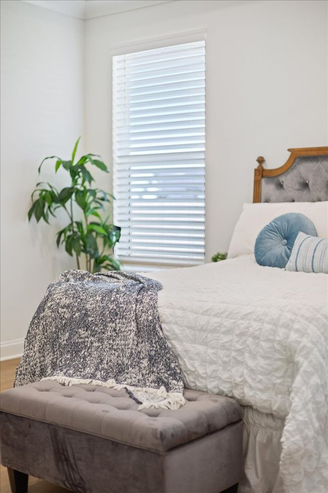 Bedroom featuring multiple windows and wood finished floors | Image 16