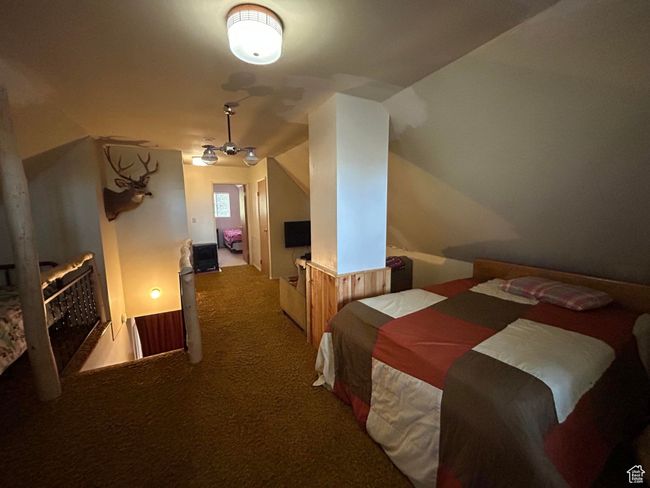 Carpeted bedroom with vaulted ceiling | Image 27