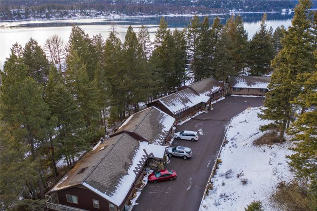 Snowy aerial view with a forest view and a water view | Image 4