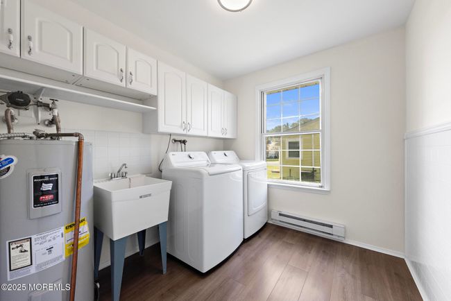 Laundry room with sink and new washer and dryer | Image 21
