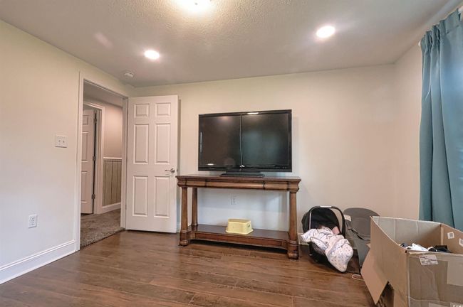Living room featuring wood finished floors, recessed lighting, and a textured ceiling | Image 21