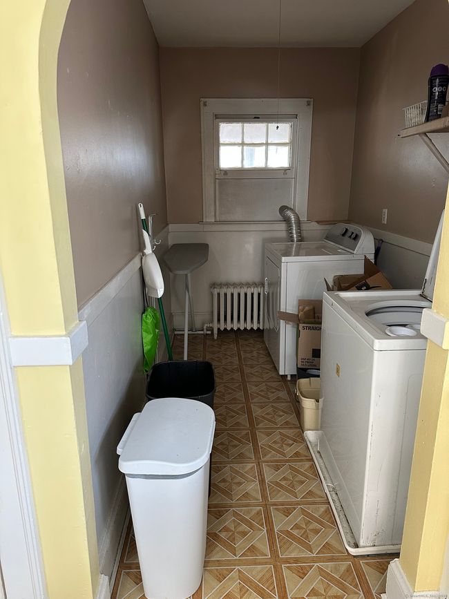 Laundry area located inside of the unit right off of the kitchen. The dryer vent will be reconfigured to vent outside once the window is replaced and the floor is going to be replaced as well. | Image 10