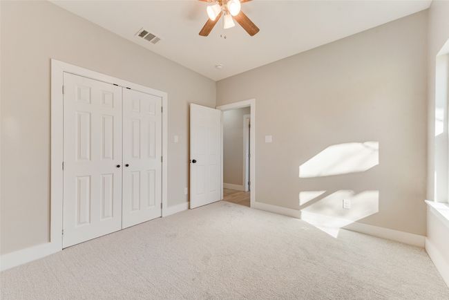 Unfurnished bedroom featuring carpet, a closet, and a ceiling fan | Image 21