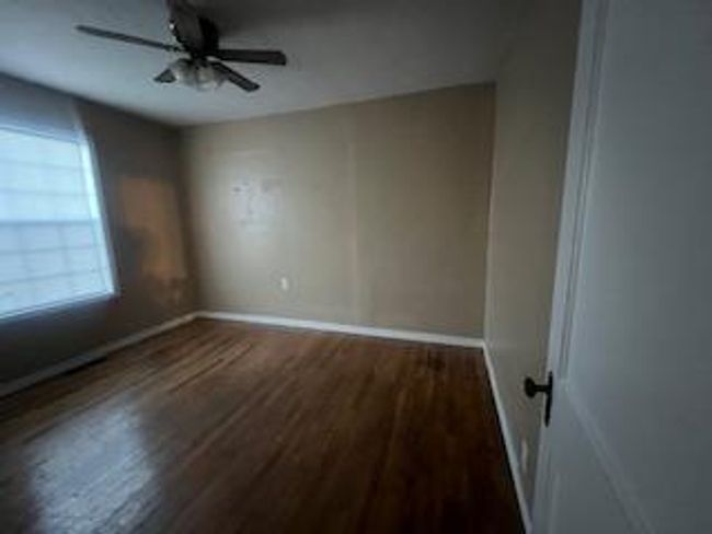 Unfurnished room with wood finished floors, baseboards, and a ceiling fan | Image 10