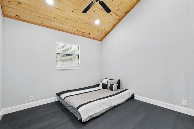 Bedroom featuring baseboards, dark wood-style floors, wood ceiling, vaulted ceiling, and recessed lighting | Image 27