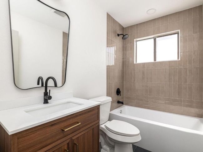 Bathroom featuring vanity, toilet, and bathing tub / shower combination | Image 20