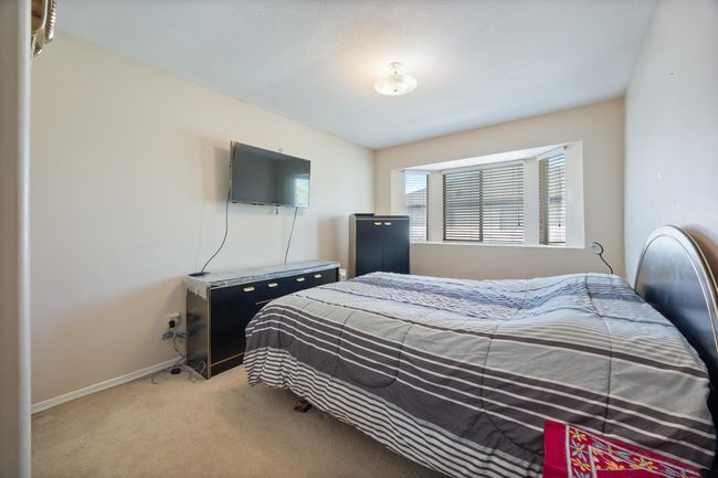 Bedroom with light carpet and baseboards | Image 28