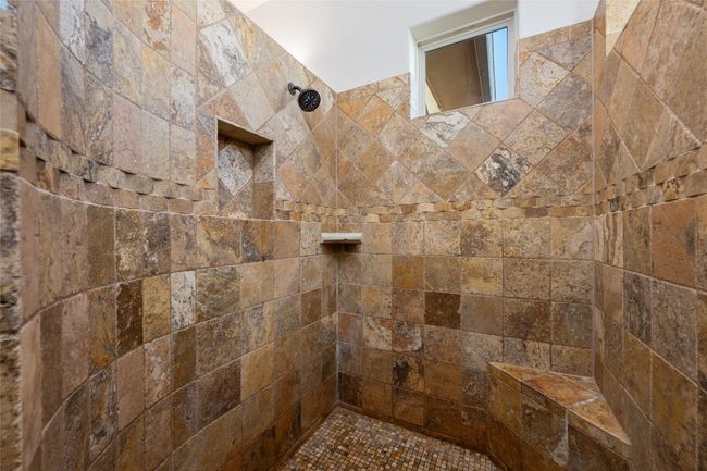 Stone shower with two shower heads. | Image 16