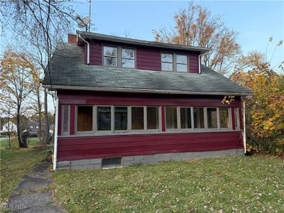 View of property exterior with a yard | Image 1