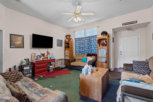 Carpeted living room with ceiling fan | Image 10