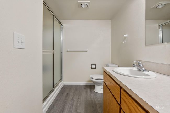 Full bath featuring a stall shower, vanity, and wood finished floors | Image 30