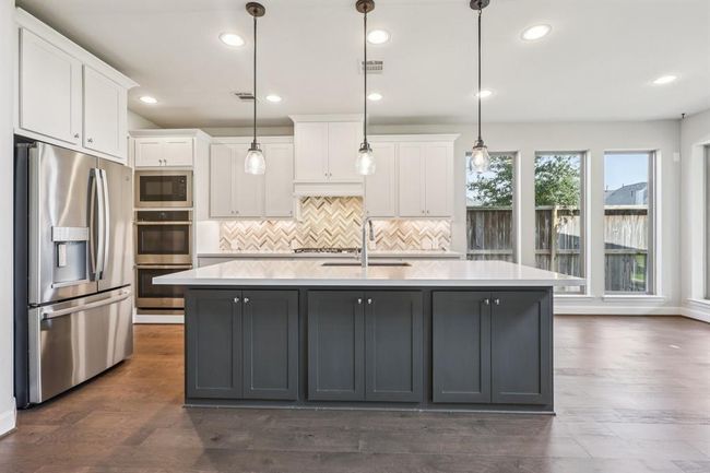 Chef-Inspired Kitchen DesignExperience the heart of the home with stainless steel appliances, a sleek gas range, and double ovens—perfect for entertaining or everyday meals. | Image 13