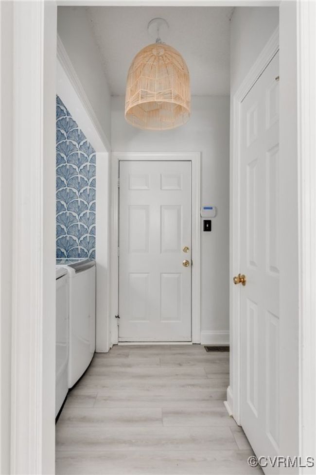 Laundry room with view of garage entry | Image 22