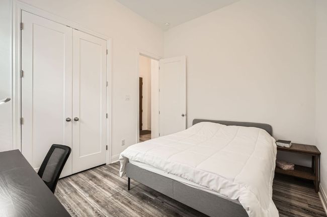 Bedroom with wood finished floors, a closet, and a desk | Image 23
