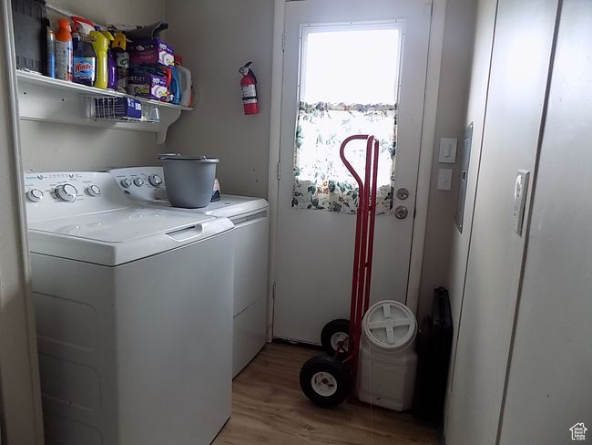 Laundry area with light hardwood / wood-style flooring and washer and dryer | Image 19