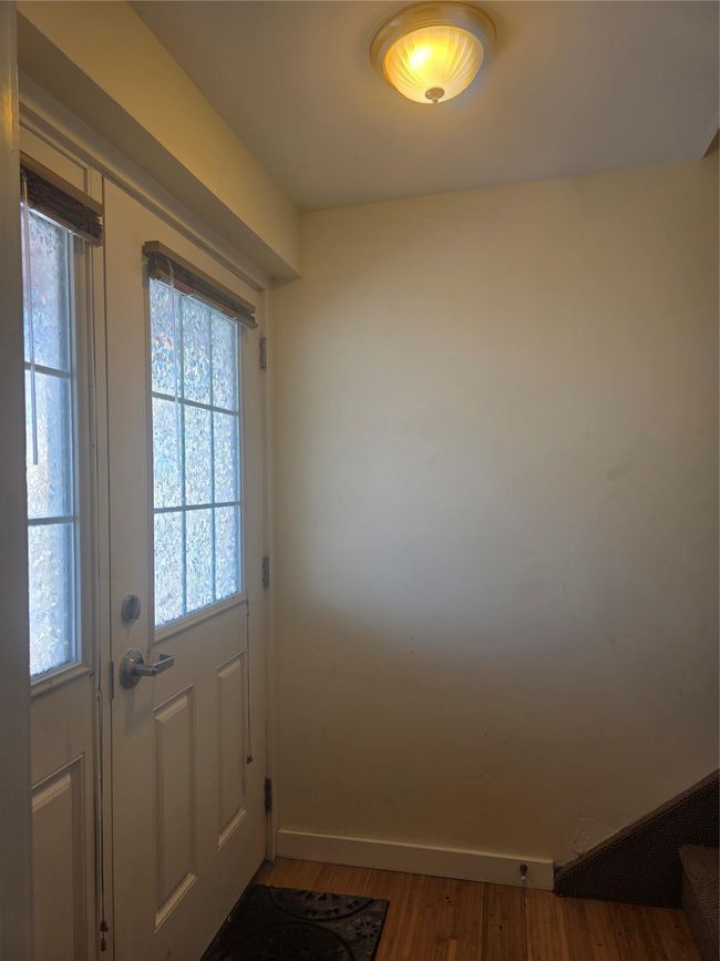 Entryway with baseboards and wood finished floors | Image 11