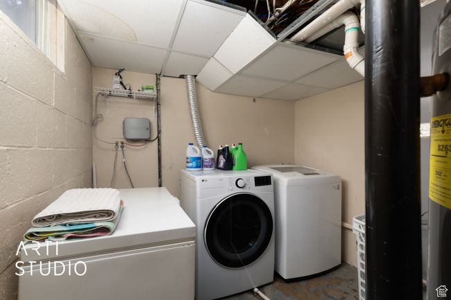 Laundry room with washer and dryer and concrete block wall | Image 5
