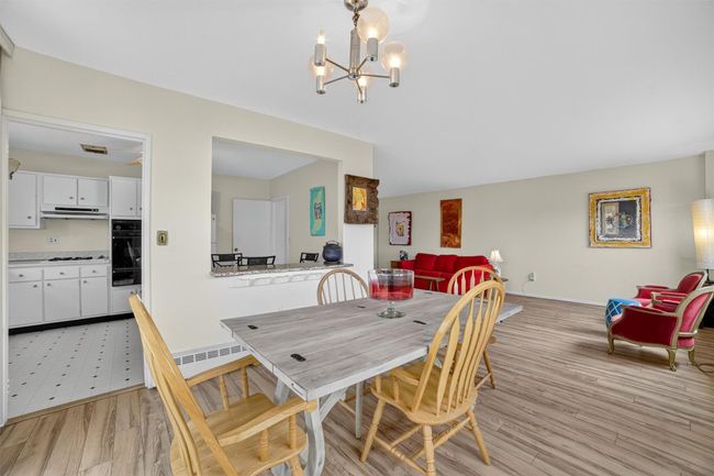 Dining space with a chandelier and light wood-type flooring | Image 16