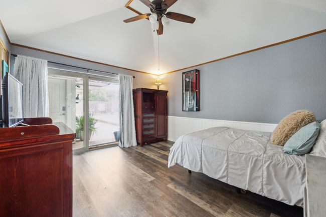 Bedroom with Sliders and Wainscoting Accents | Image 27