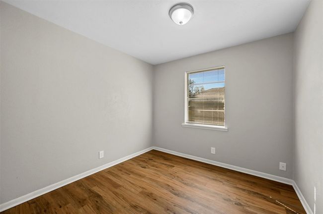 Empty room with wood finished floors and baseboards | Image 9