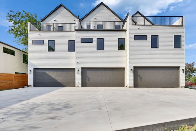 Townhome / multi-family property featuring a garage, concrete driveway, and a balcony | Image 8