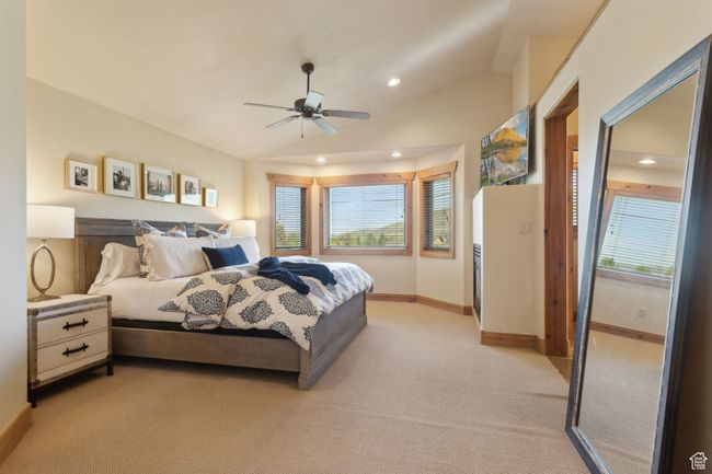 Bedroom with light carpet, multiple windows, recessed lighting, baseboards, and vaulted ceiling | Image 24
