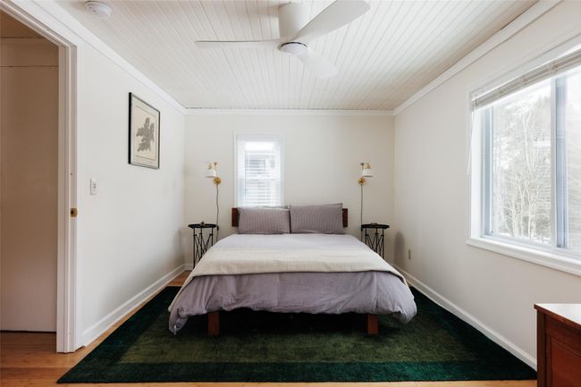 Bedroom with crown molding, ceiling fan, hardwood / wood-style floors, and wooden ceiling | Image 11