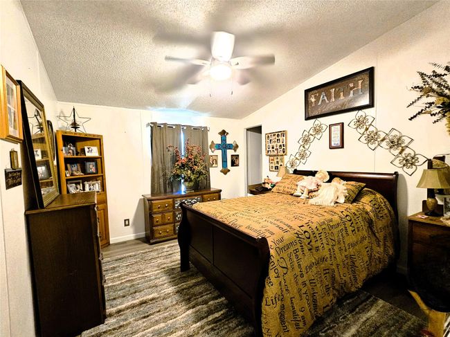 Bedroom featuring a textured ceiling and a ceiling fan | Image 16