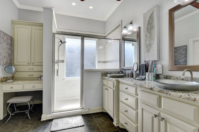 Full bath with double vanity, a stall shower, crown molding, and recessed lighting | Image 21