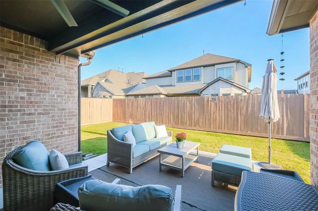 View of the covered patio over the extended tiled patio. You’ll appreciate the ceiling fan here! | Image 31