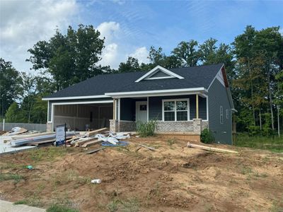 View of front of house featuring a porch and a garage | Image 1