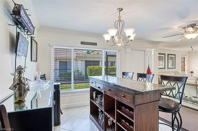 Dining area featuring baseboards, ornamental molding, and ceiling fan with notable chandelier | Image 18