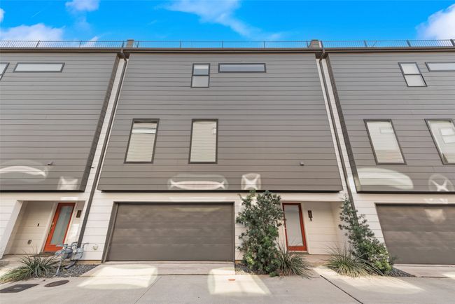 Townhome / multi-family property featuring concrete driveway and a garage | Image 4