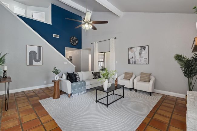 Tiled living room featuring beamed ceiling, ceiling fan, and high vaulted ceiling | Image 8
