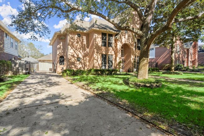 Shade trees and a gated driveway make this home extra special! | Image 41