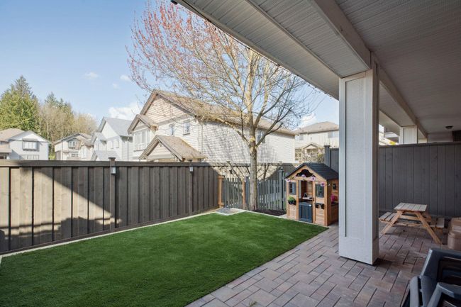 View of yard with a patio area, a fenced backyard, and a residential view | Image 34