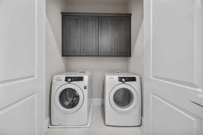 Laundry area with washing machine and clothes dryer and cabinet space | Image 29