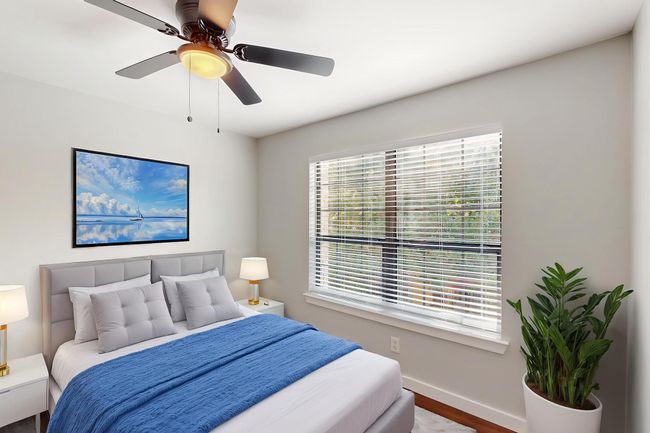 Bedroom with ceiling fan, wood finished floors, and baseboards | Image 33