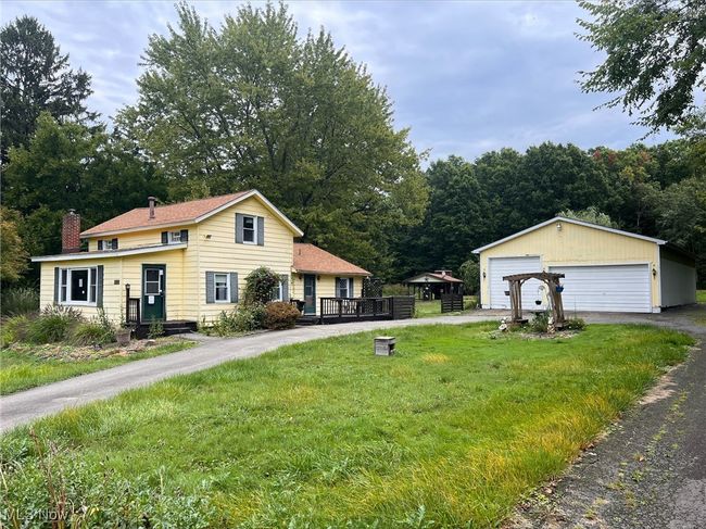 View of front of house with a garage, a front yard, and an outbuilding | Image 5