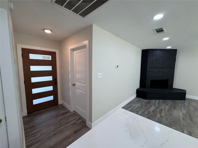 Foyer entrance featuring wood finished floors, baseboards, and visible vents | Image 4