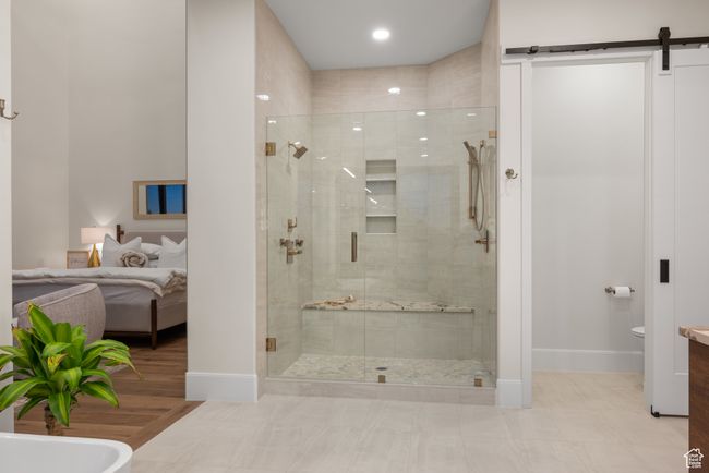 Ensuite bathroom featuring a shower stall and baseboards | Image 41