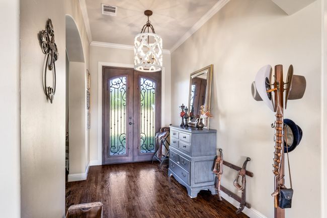 Foyer entrance featuring french doors, dark wood-type flooring, and ornamental molding | Image 9