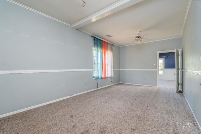 Carpeted spare room with ceiling fan and crown molding | Image 17