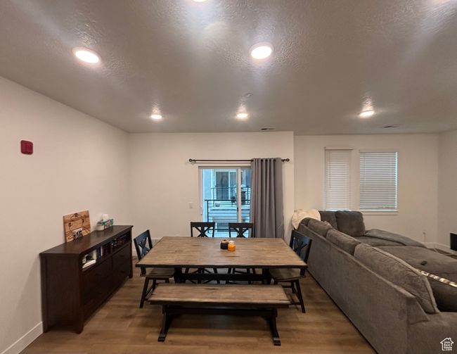 Dining area featuring light wood finished floors, recessed lighting, baseboards, and a textured ceiling | Image 4