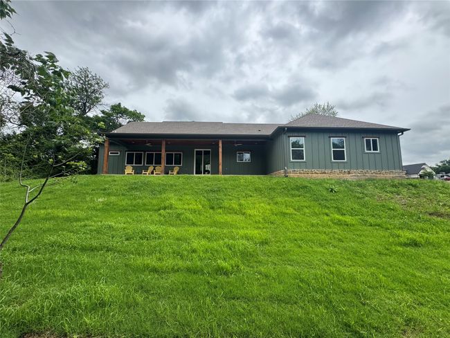 Back of house with a lawn and board and batten siding | Image 37