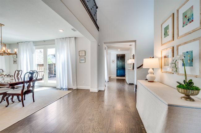 Step inside and take in the beautifully designed floor plan. The formal dining room offers views of the private courtyard, while guests are welcomed by a spacious entryway and staircase to the right. | Image 5