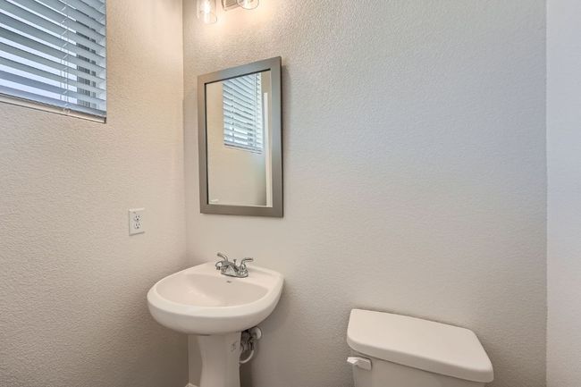 Bathroom with toilet and a textured wall | Image 14