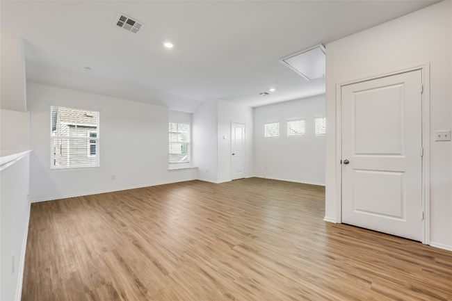 Unfurnished garage apartment featuring light wood-style floors, attic access, and recessed lighting | Image 31